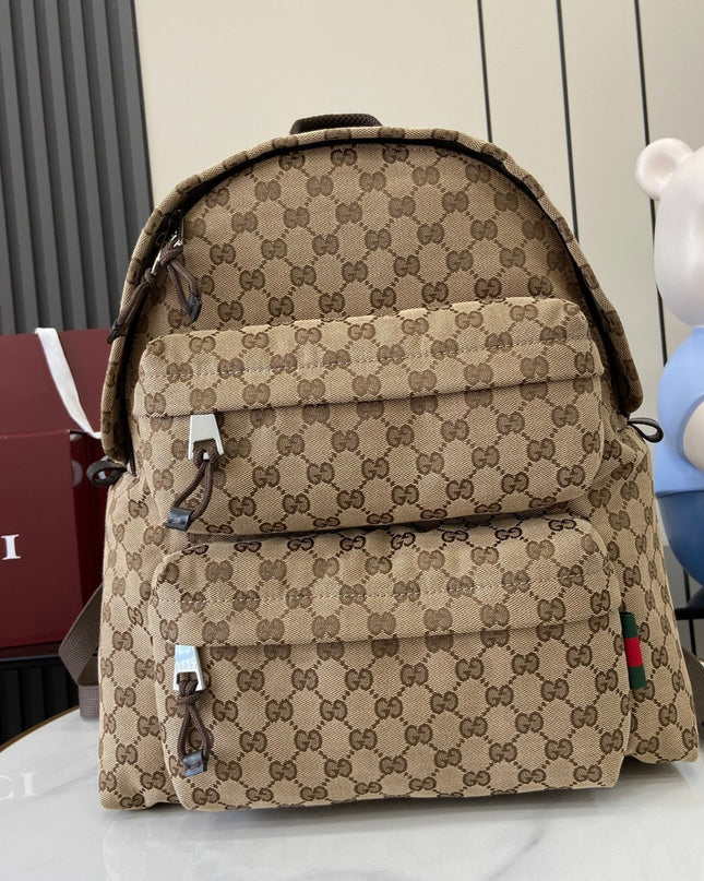 Beige backpack with Gucci logo pattern on a white surface with a blurred background