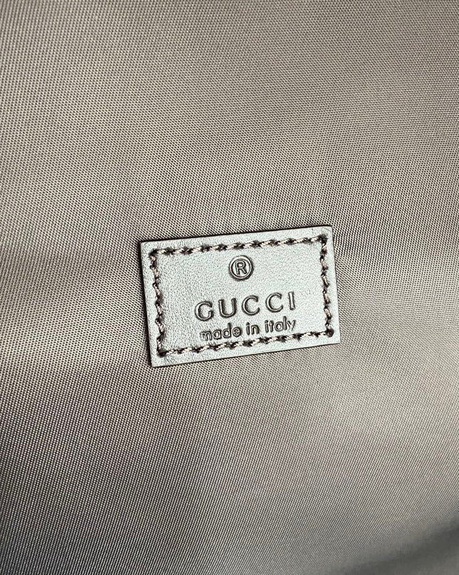 Gucci label on a gray fabric background