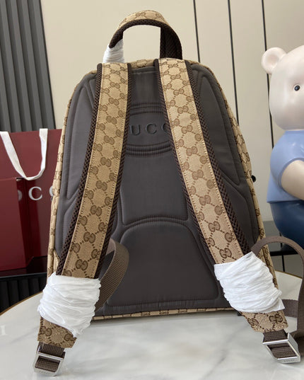 Backpack with patterned straps next to a teddy bear and Gucci bags