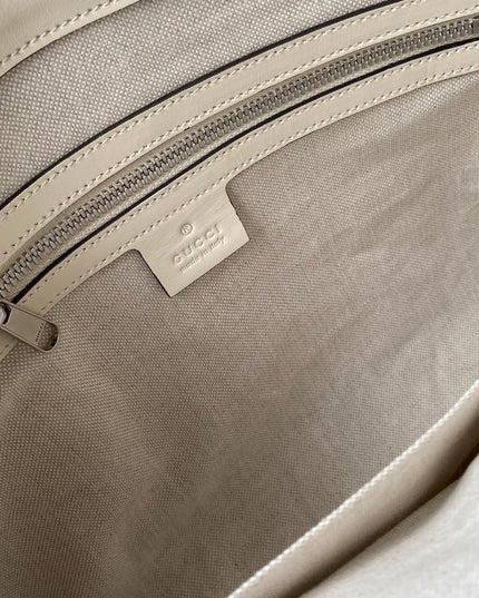 Gucci GG Embossed Leather Messenger Bag –  Beige