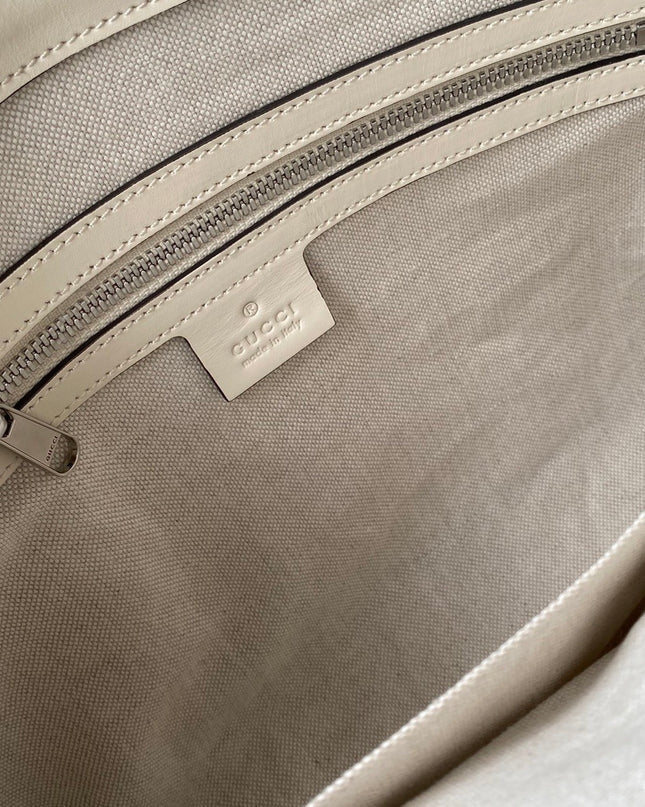 Gucci GG Embossed Leather Messenger Bag –  Beige