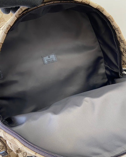 Close-up of a Gucci bag with a visible logo inside.