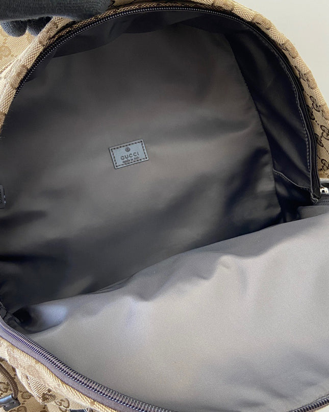 Close-up of a Gucci bag with a visible logo inside.