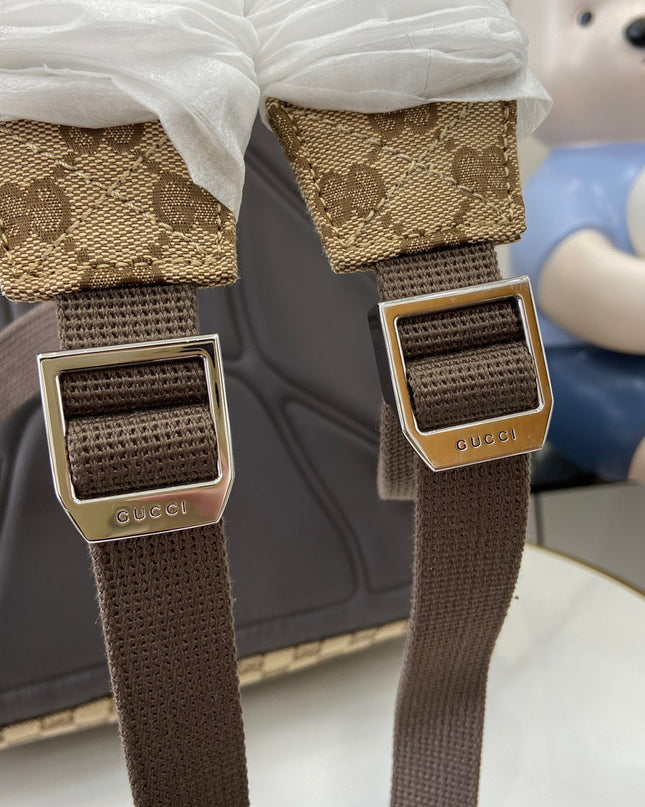 Brown Gucci straps with floral patterned ends on a blurred background
